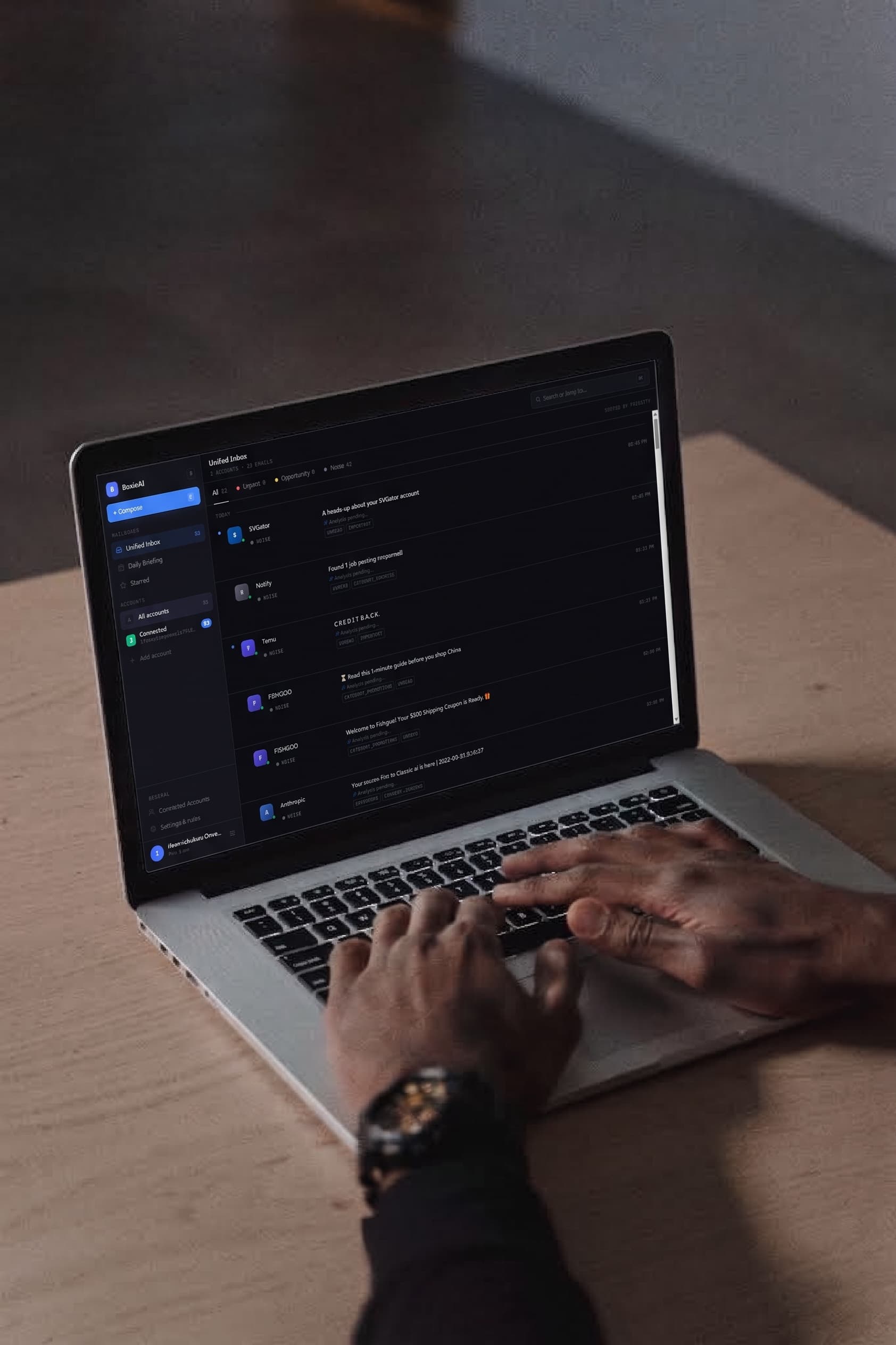 Over-the-shoulder view of the BoxieAI unified inbox open on a laptop